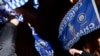 Leicester City fans wave flags as they celebrates their team becoming the English Premier League football champions in central Leicester, eastern England